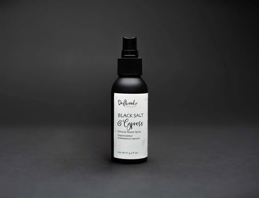 Image of Driftwood Candle Co. Black Salt & Cypress scented room spray.  Black bottle on a black backdrop for a moody image.