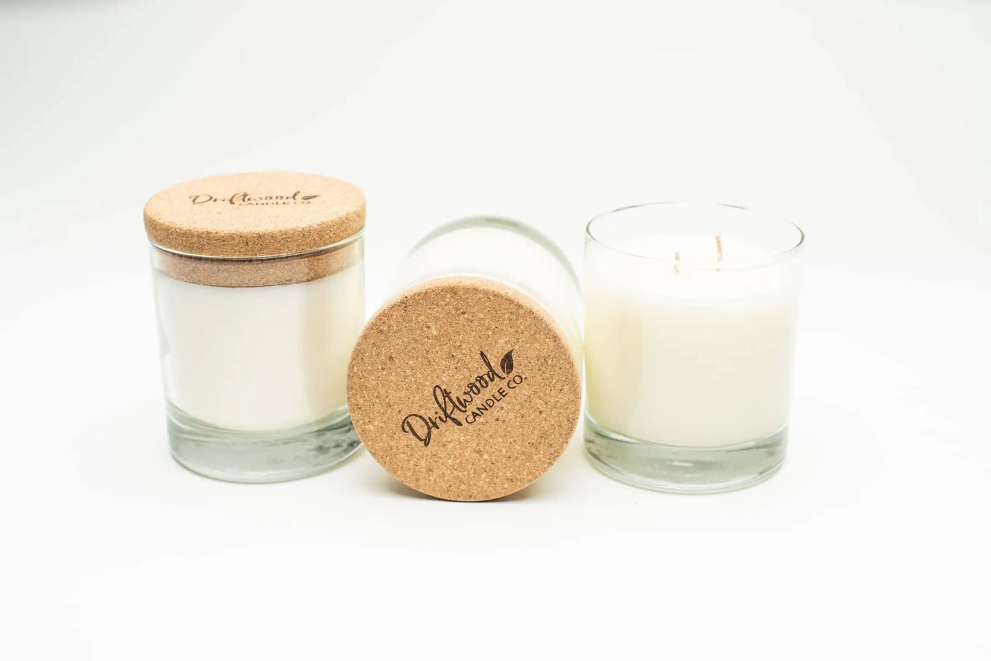 Amber Wood soy candles with cork lids.  Reusable whiskey glasses filled with double wick sandalwood and vanilla scented candles